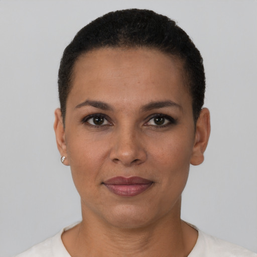 Joyful black young-adult female with short  black hair and brown eyes