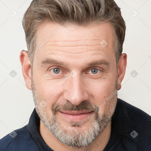 Joyful white adult male with short  brown hair and grey eyes