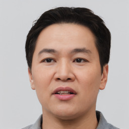 Joyful white adult male with short  black hair and brown eyes