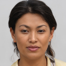 Joyful asian young-adult female with medium  brown hair and brown eyes