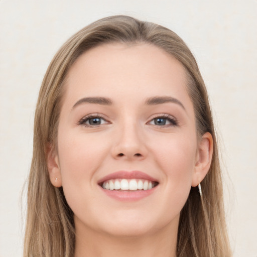 Joyful white young-adult female with long  brown hair and grey eyes