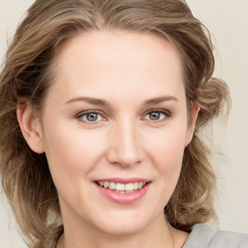 Joyful white young-adult female with medium  brown hair and blue eyes