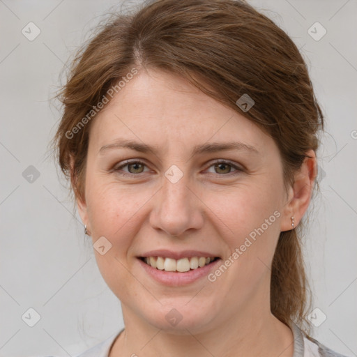 Joyful white young-adult female with medium  brown hair and grey eyes