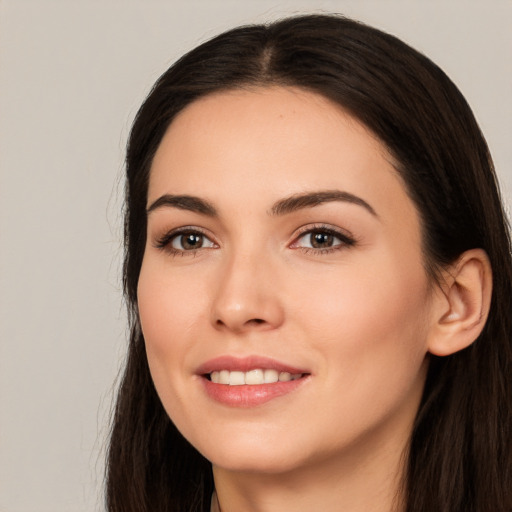 Joyful white young-adult female with long  black hair and brown eyes