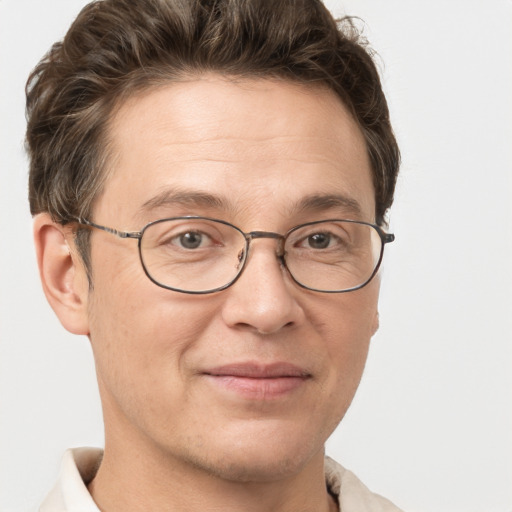 Joyful white adult male with short  brown hair and grey eyes