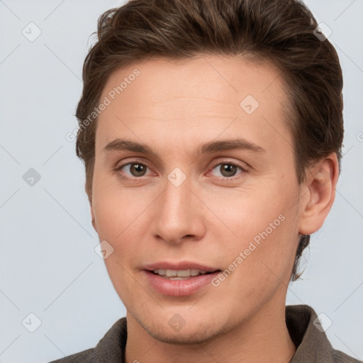 Joyful white young-adult male with short  brown hair and brown eyes