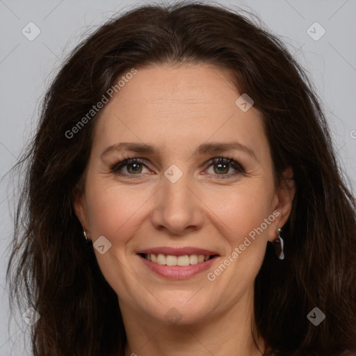 Joyful white adult female with long  brown hair and brown eyes