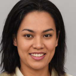 Joyful latino young-adult female with long  brown hair and brown eyes