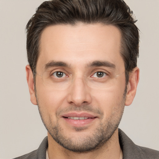 Joyful white adult male with short  brown hair and brown eyes