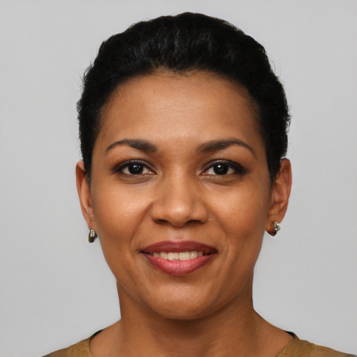 Joyful latino young-adult female with short  black hair and brown eyes