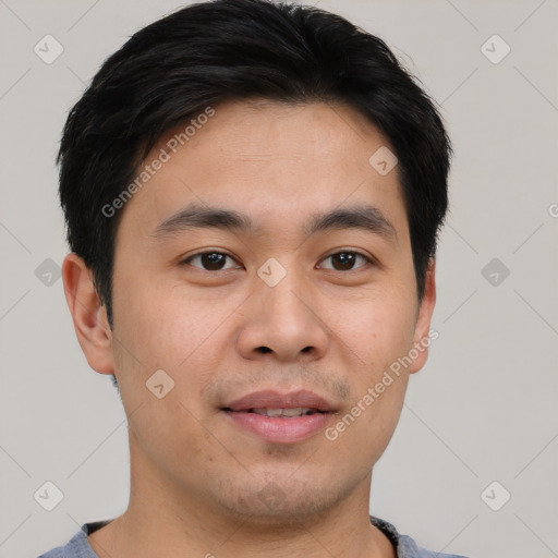 Joyful asian young-adult male with short  brown hair and brown eyes