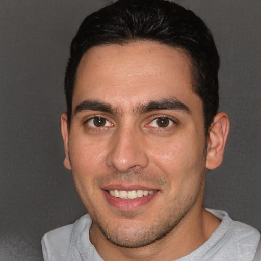 Joyful white young-adult male with short  brown hair and brown eyes