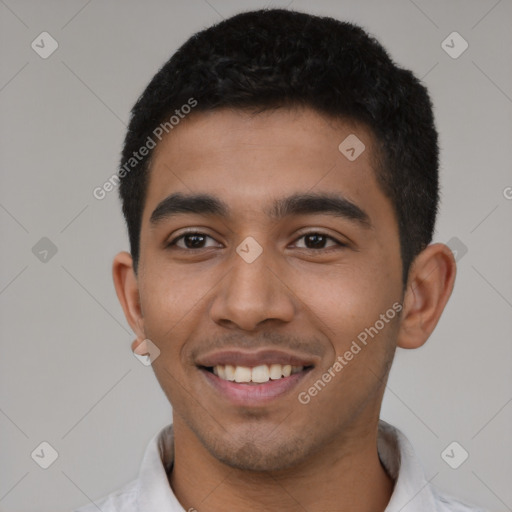 Joyful latino young-adult male with short  black hair and brown eyes