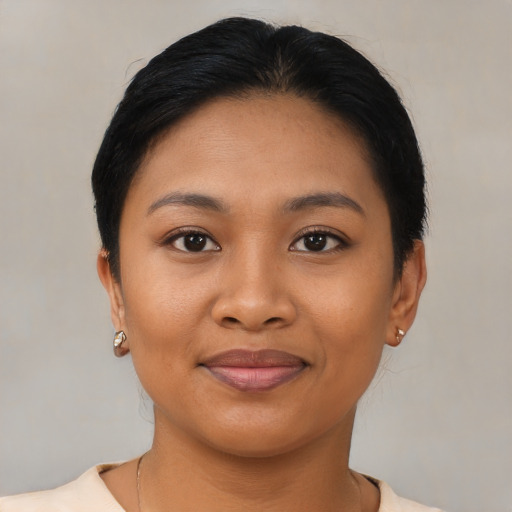 Joyful latino young-adult female with short  black hair and brown eyes