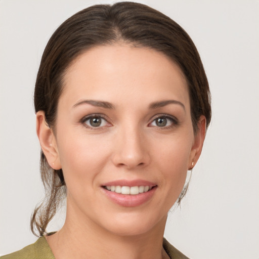 Joyful white young-adult female with medium  brown hair and brown eyes