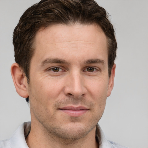 Joyful white adult male with short  brown hair and grey eyes