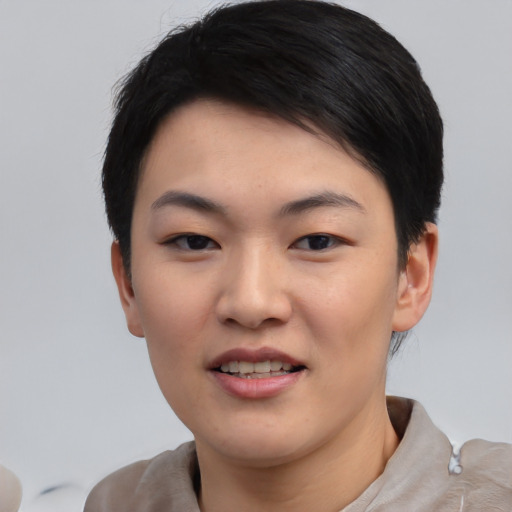 Joyful asian young-adult female with short  black hair and brown eyes
