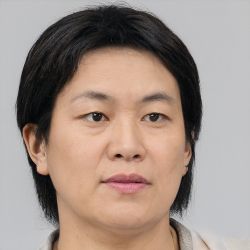 Neutral asian adult female with medium  brown hair and brown eyes