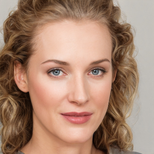 Joyful white young-adult female with medium  brown hair and green eyes