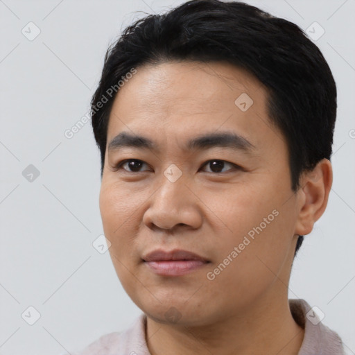 Joyful asian young-adult male with short  black hair and brown eyes