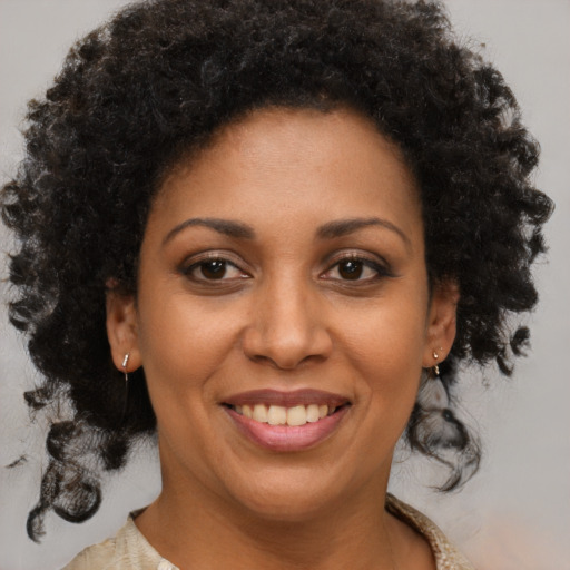 Joyful black young-adult female with medium  brown hair and brown eyes