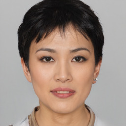 Joyful asian young-adult female with short  black hair and brown eyes