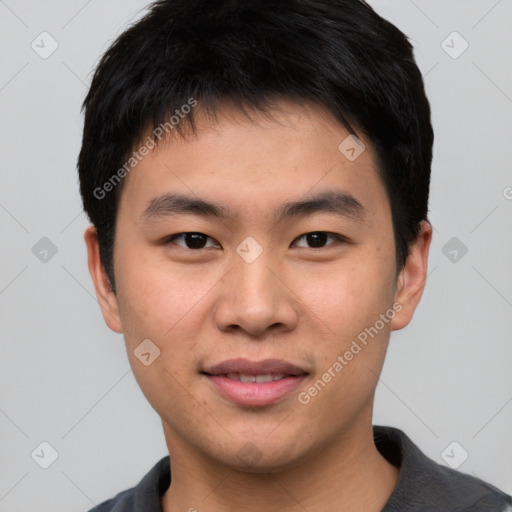 Joyful asian young-adult male with short  black hair and brown eyes