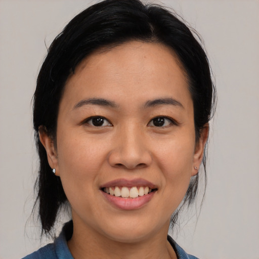 Joyful asian young-adult female with medium  black hair and brown eyes