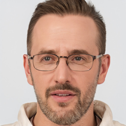 Joyful white adult male with short  brown hair and brown eyes