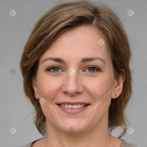 Joyful white adult female with medium  brown hair and grey eyes