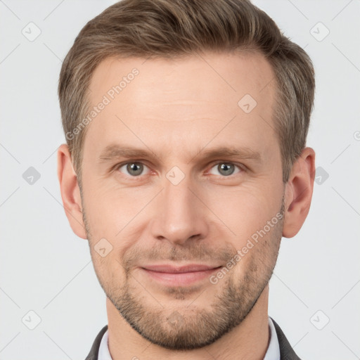 Joyful white young-adult male with short  brown hair and grey eyes