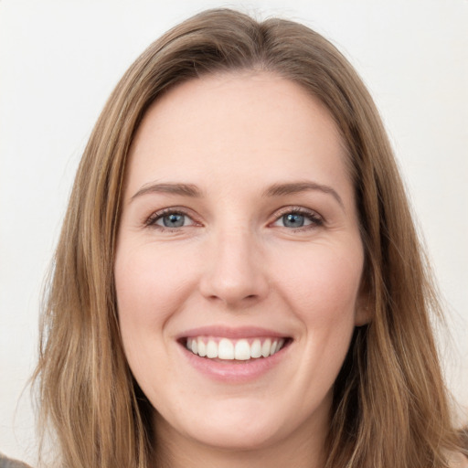 Joyful white young-adult female with long  brown hair and grey eyes