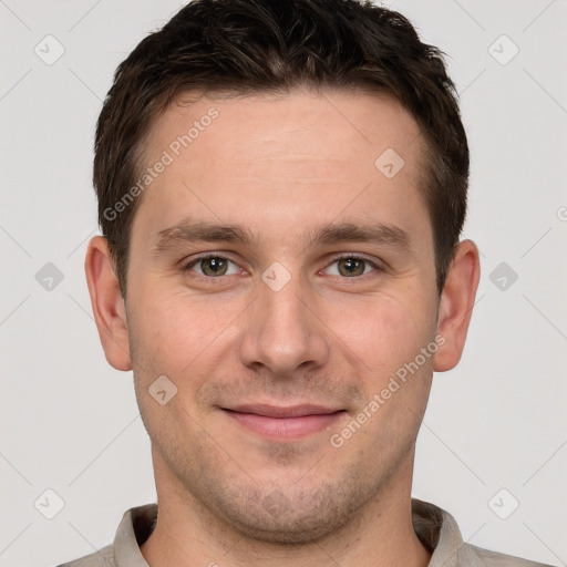 Joyful white young-adult male with short  brown hair and grey eyes