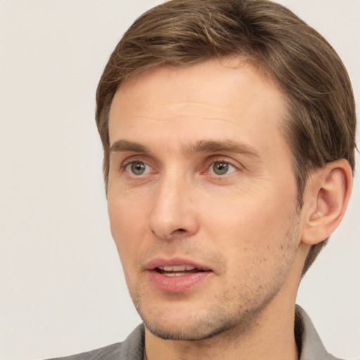 Joyful white adult male with short  brown hair and brown eyes