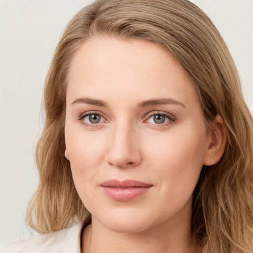 Joyful white young-adult female with long  brown hair and blue eyes