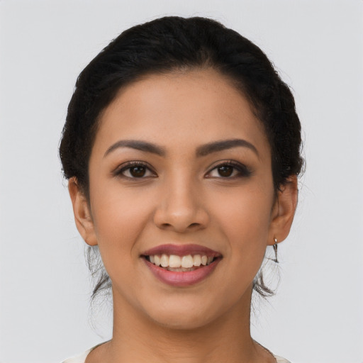 Joyful latino young-adult female with long  brown hair and brown eyes