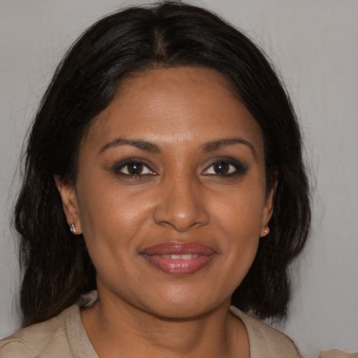 Joyful black young-adult female with medium  brown hair and brown eyes