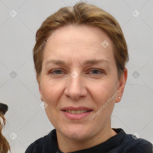 Joyful white adult female with short  brown hair and brown eyes