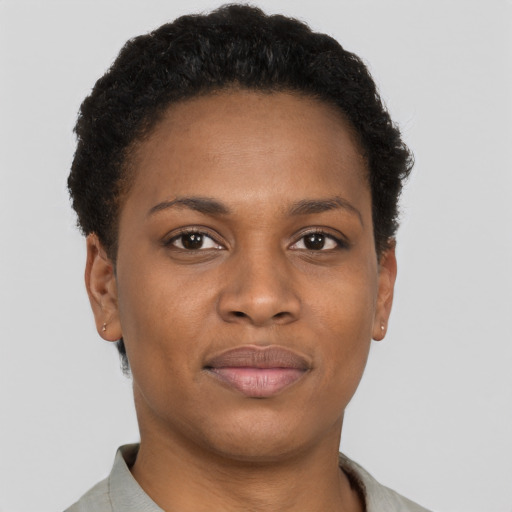 Joyful black young-adult female with short  brown hair and brown eyes