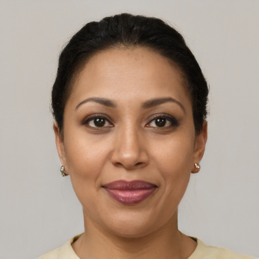 Joyful latino adult female with short  brown hair and brown eyes