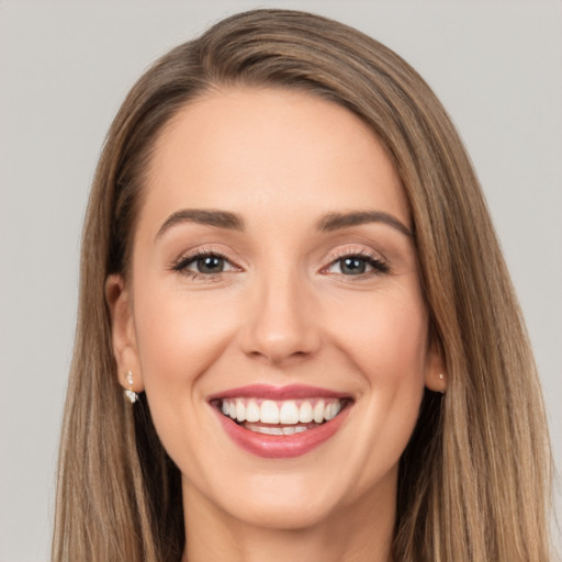 Joyful white young-adult female with long  brown hair and brown eyes