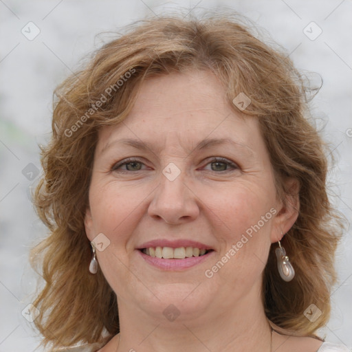 Joyful white adult female with medium  brown hair and blue eyes