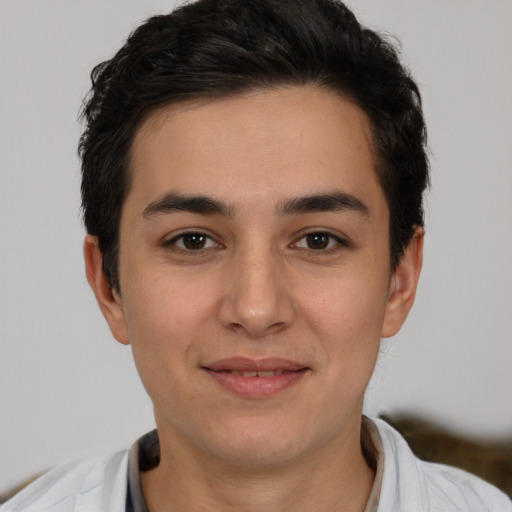 Joyful white young-adult male with short  black hair and brown eyes