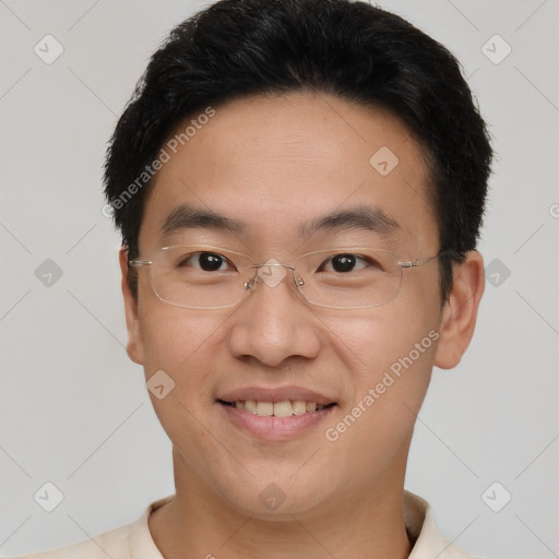 Joyful asian young-adult male with short  brown hair and brown eyes