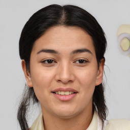 Joyful latino young-adult female with medium  brown hair and brown eyes