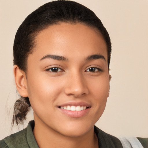 Joyful latino young-adult female with short  brown hair and brown eyes