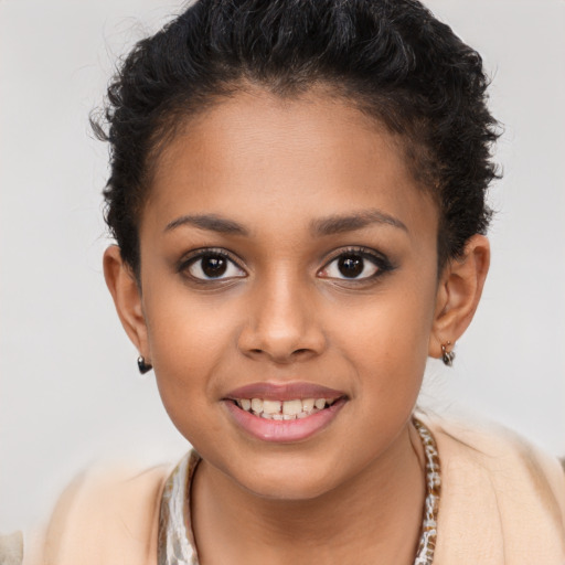 Joyful latino child female with short  brown hair and brown eyes