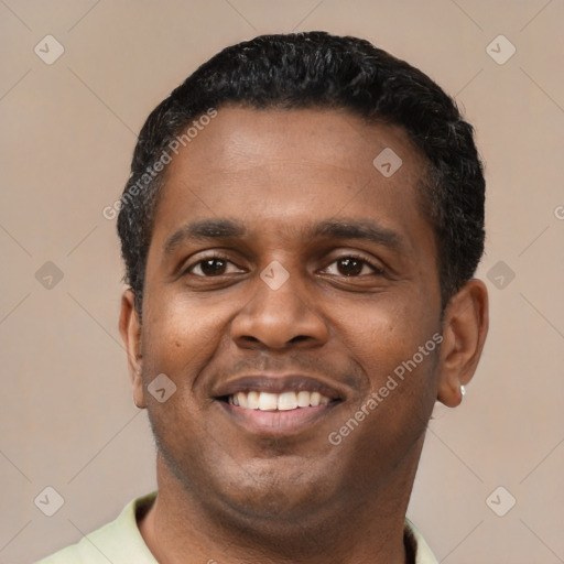 Joyful latino young-adult male with short  black hair and brown eyes