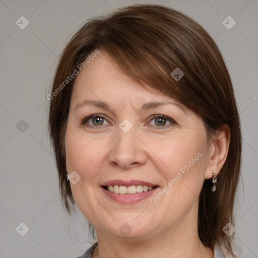 Joyful white adult female with medium  brown hair and grey eyes