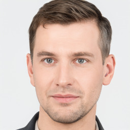 Joyful white young-adult male with short  brown hair and grey eyes